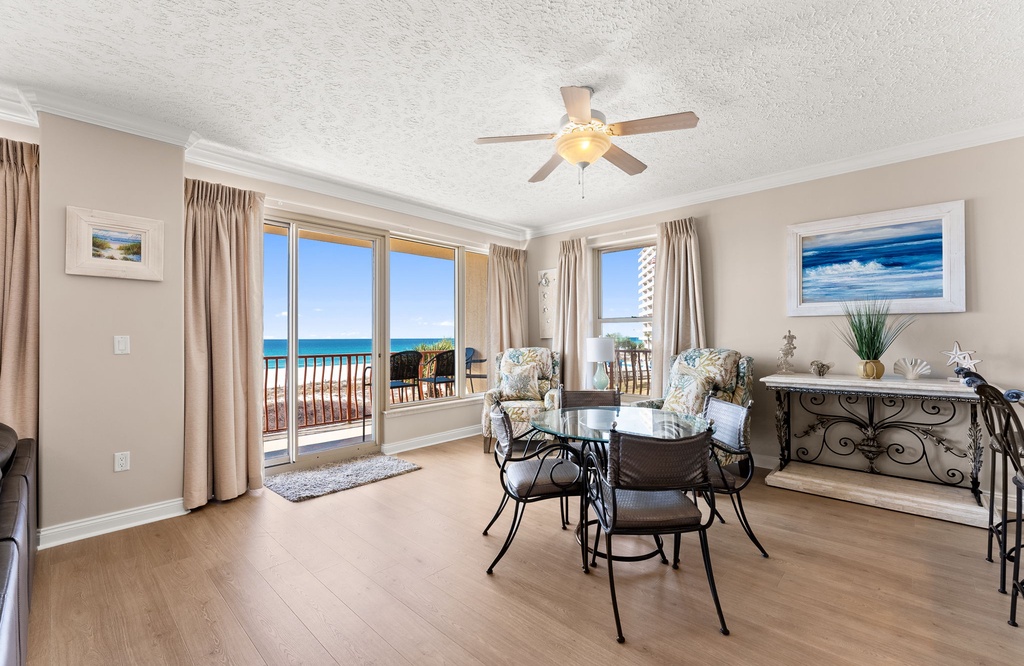 Relax in this bright living area with ocean views and access to a balcony.
