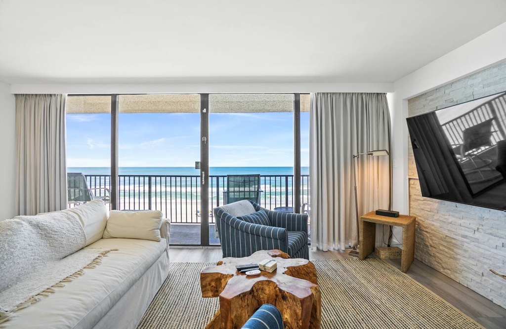 Your living room opens onto a private balcony with stunning ocean views—perfect for morning coffee or watching the waves roll in.