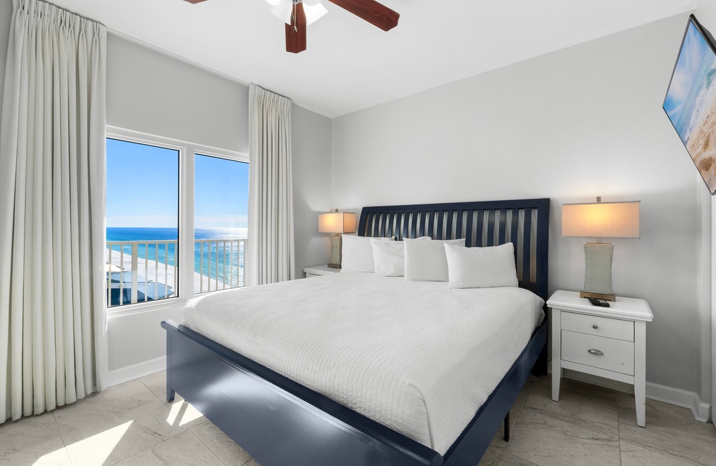 Relax in this modern bedroom with ocean views through the window.