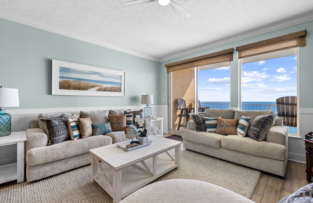 Step into your coastal haven with sweeping ocean views through floor-to-ceiling windows. Relax on plush sofas in soothing coastal hues, and let the sea breeze welcome you home.