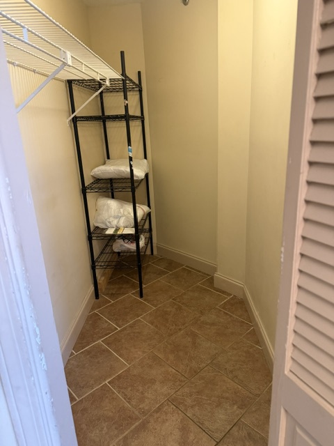 A thoughtfully organized closet with shelving and hanging space provides dedicated storage for your wardrobe and travel essentials throughout your stay.