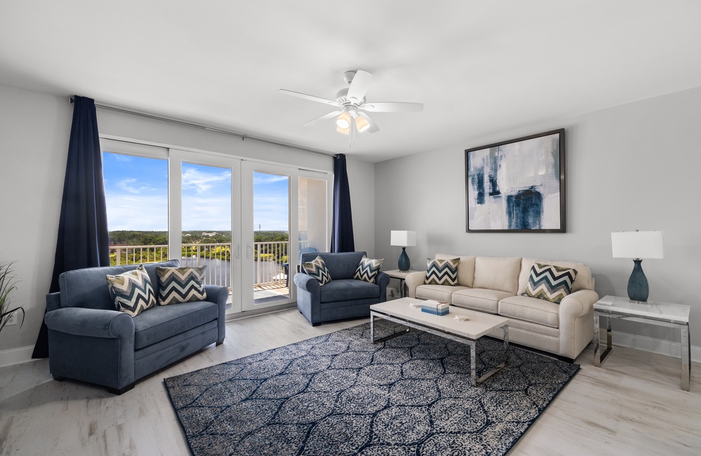 Sink into plush seating and let natural light fill your space through floor-to-ceiling windows. The balcony beckons with tree-lined views—your tranquil retreat awaits.