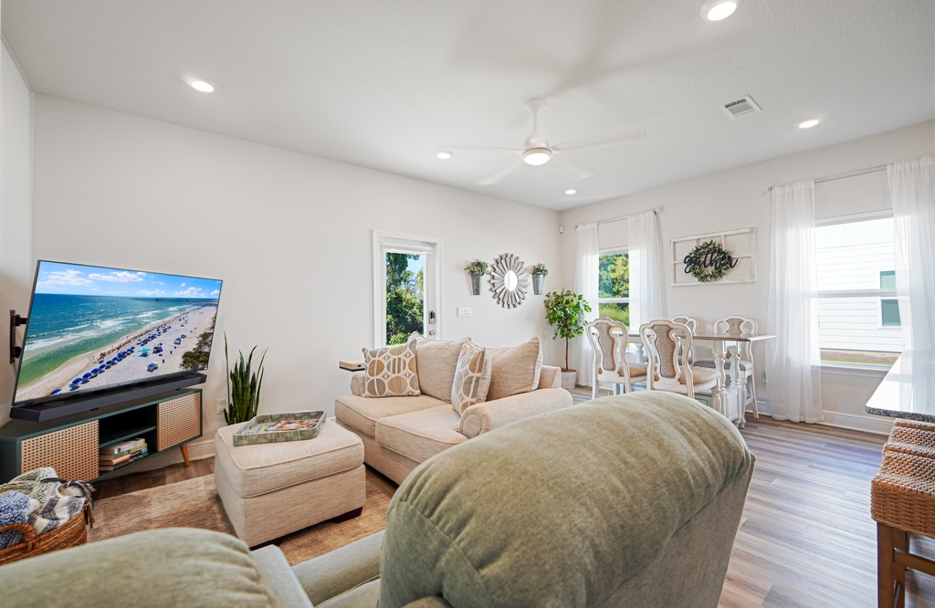 Unwind in your bright, airy living space with plush seating and a large TV, perfect for relaxing after beach days.