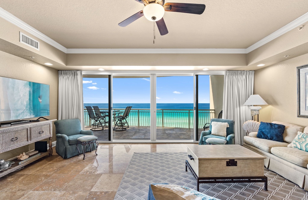 Step into your coastal sanctuary where floor-to-ceiling windows frame stunning turquoise waters stretching to the horizon. Sink into plush seating as gentle gulf breezes drift through your private balcony.
