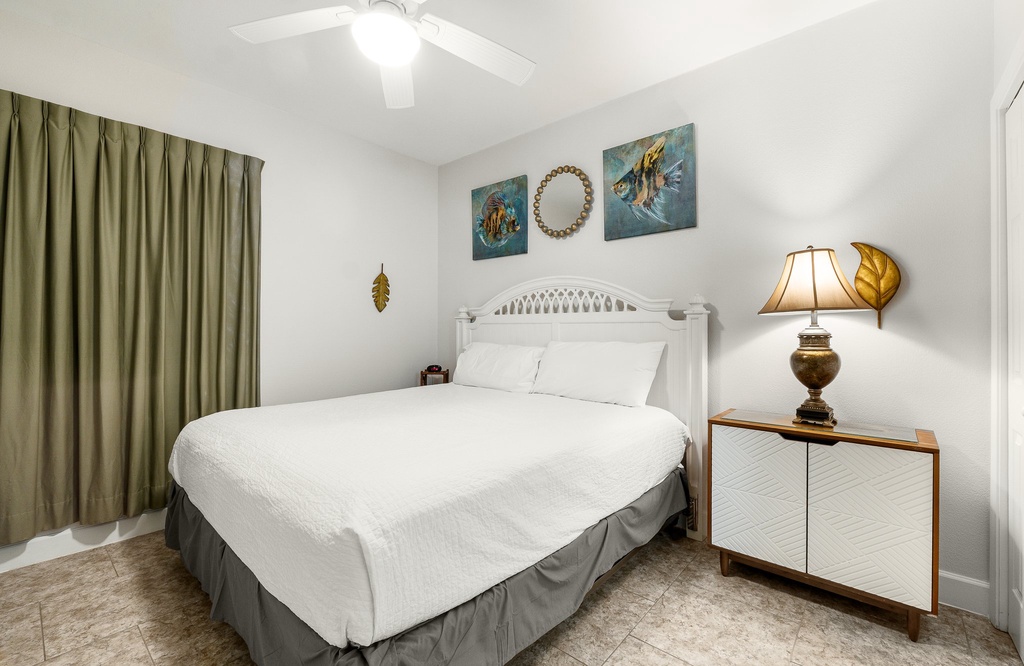 Cozy bedroom with a white bed frame and soft lighting for a restful stay
