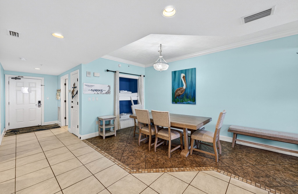 dining area with a wooden table and chairs in a light blue room