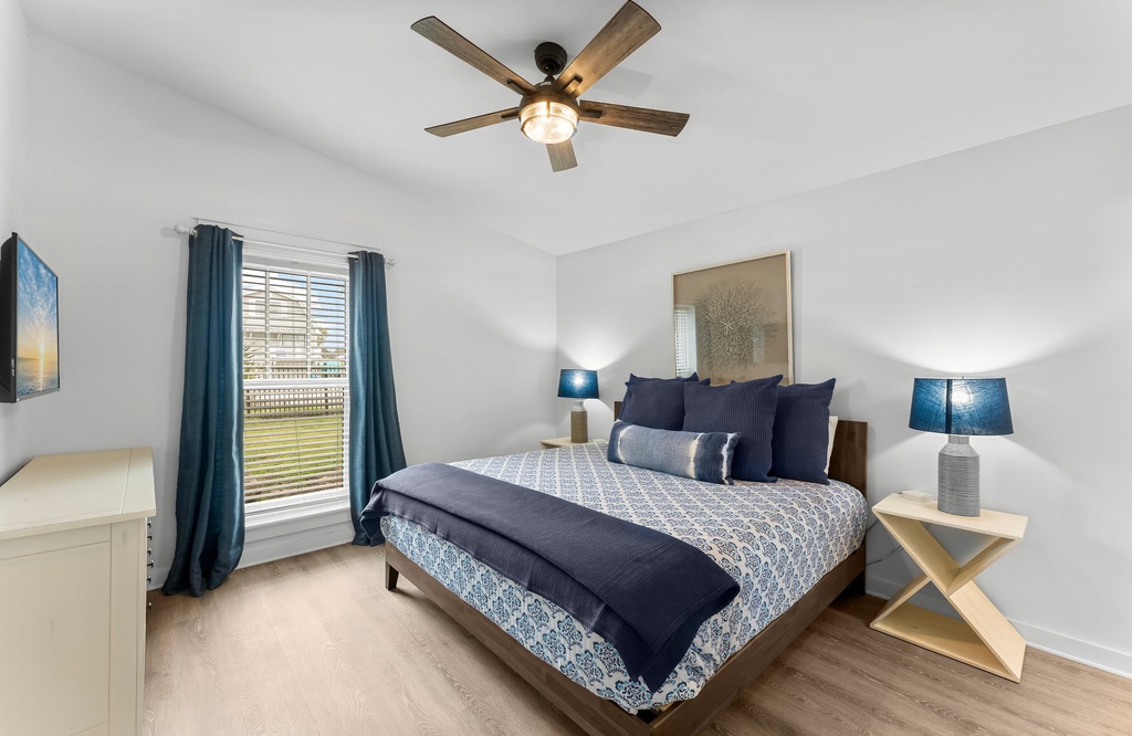 Relax in this modern bedroom with natural light and calming blue accents.