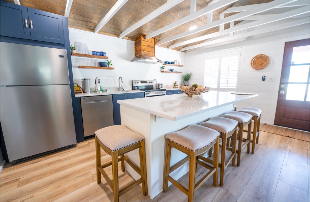 Modern kitchen with a large island and seating for five.