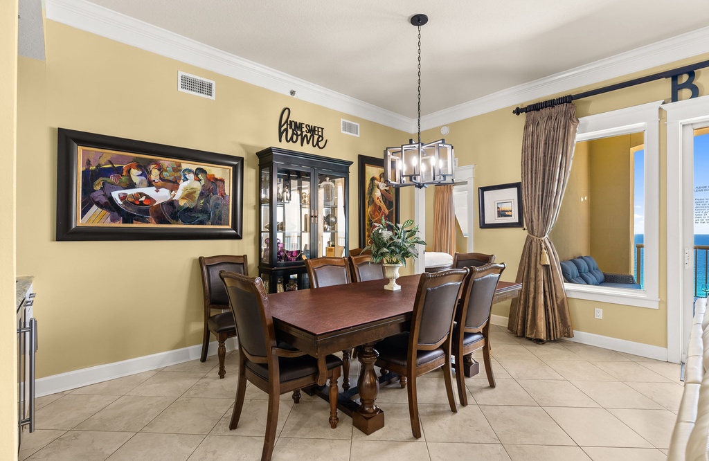 Dining area with a wooden table, leather chairs, and a glass cabinet in a warm, inviting setting