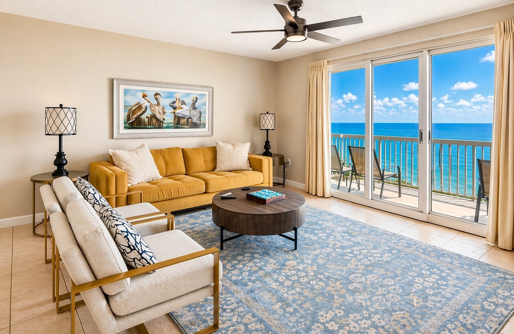 Unwind in your bright living space with plush seating and sweeping sea views. Step through the glass doors to your private balcony—perfect for morning coffee or sunset relaxation.