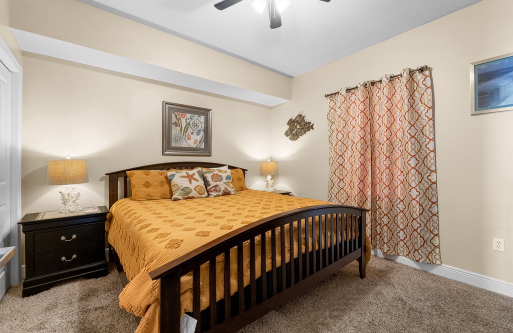Cozy bedroom featuring a wooden bed frame and warm lighting for a relaxing stay