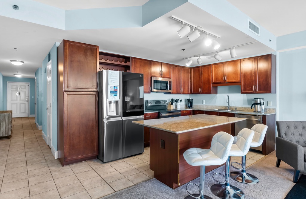 Modern kitchen with stainless steel appliances and a central island with seating.
