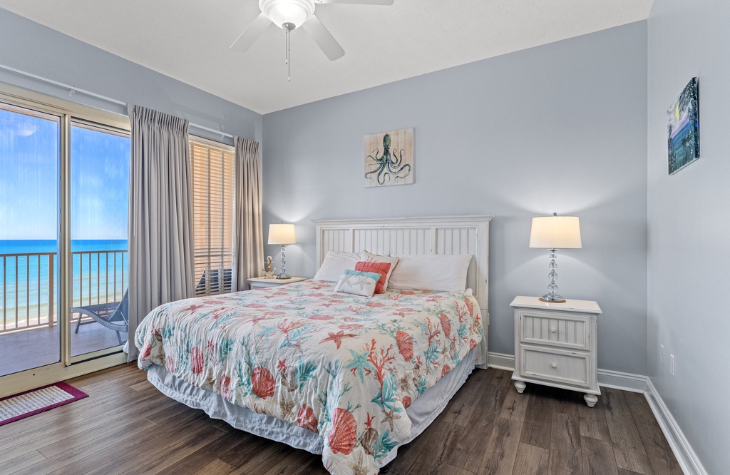 Relax in this coastal-themed bedroom with ocean views and natural light.