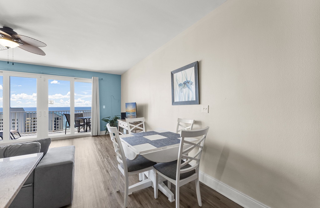 Dining area with coastal views and access to a balcony.