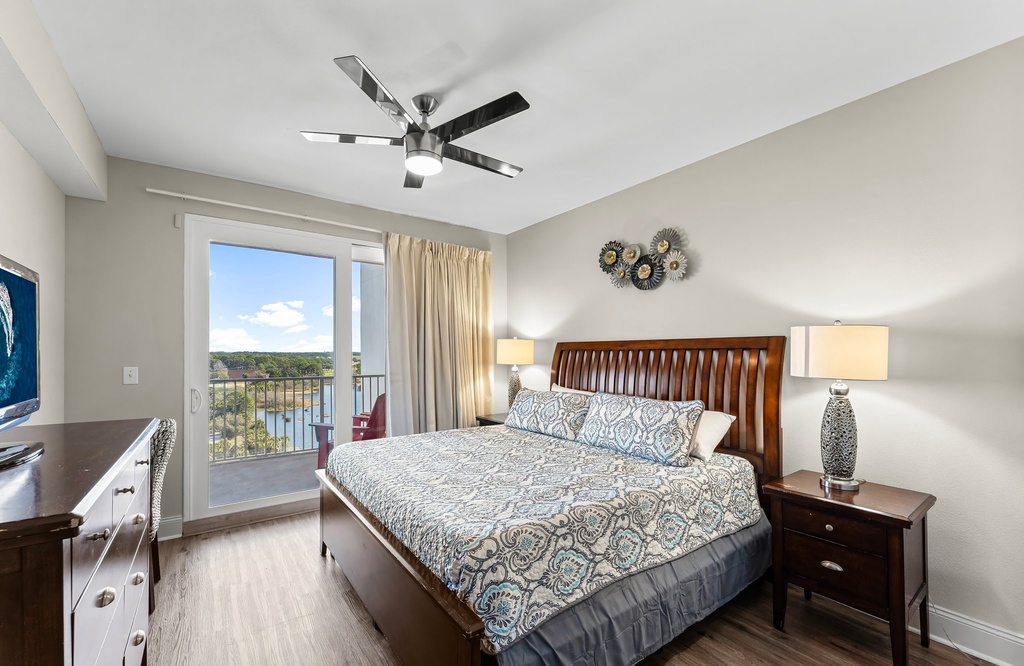 Relax in this modern bedroom with a balcony overlooking the water.