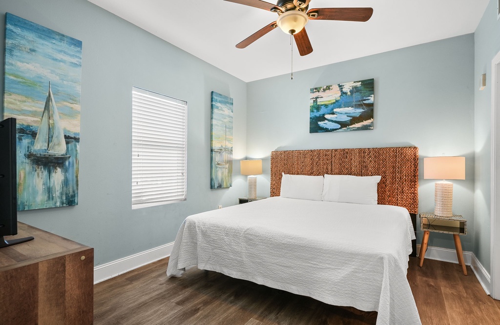 Relax in this coastal-inspired bedroom with a comfy bed and calming blue walls.