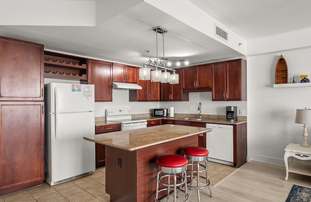 Modern kitchen with a central island and seating for two.