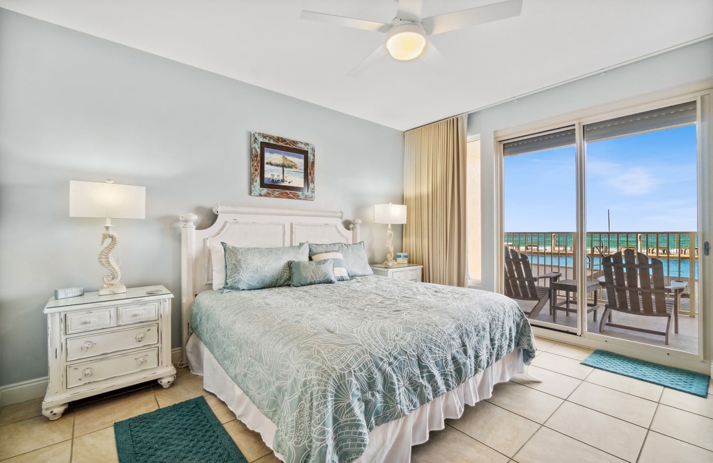 Relax in this coastal bedroom with direct balcony access and ocean views.