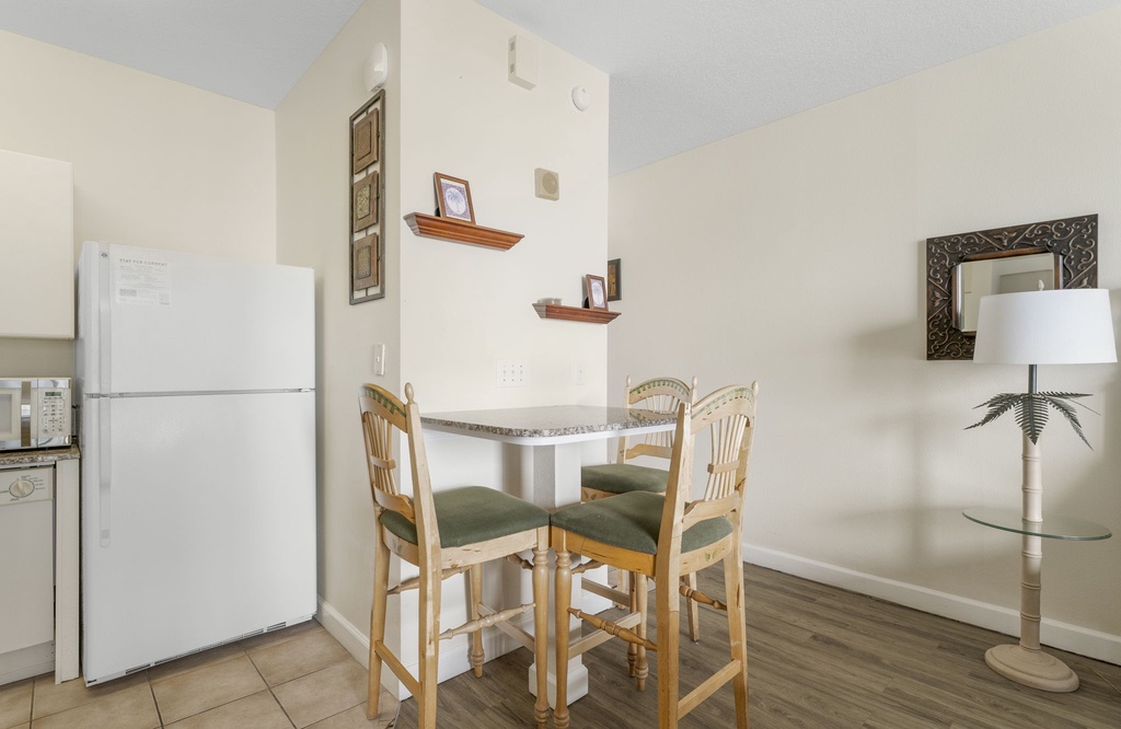 Bright dining area w/ a small table & chairs — just right for a casual meal in.