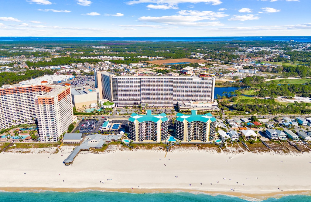 Stunning beachfront resort complex positioned directly on pristine sandy shores with crystal-clear waters.