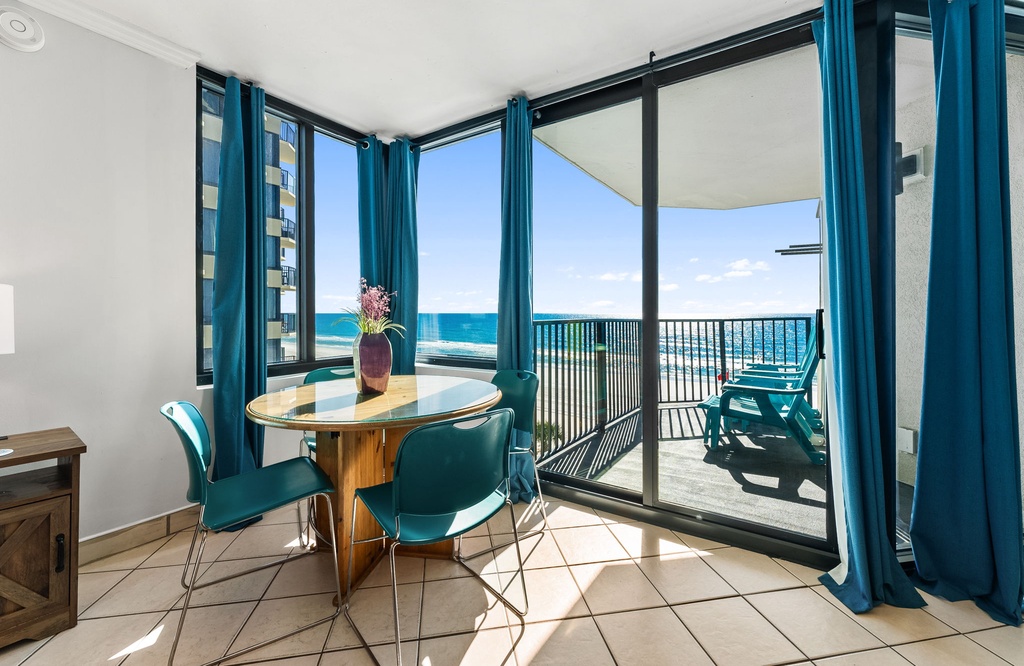 dining area with ocean views and access to a balcony