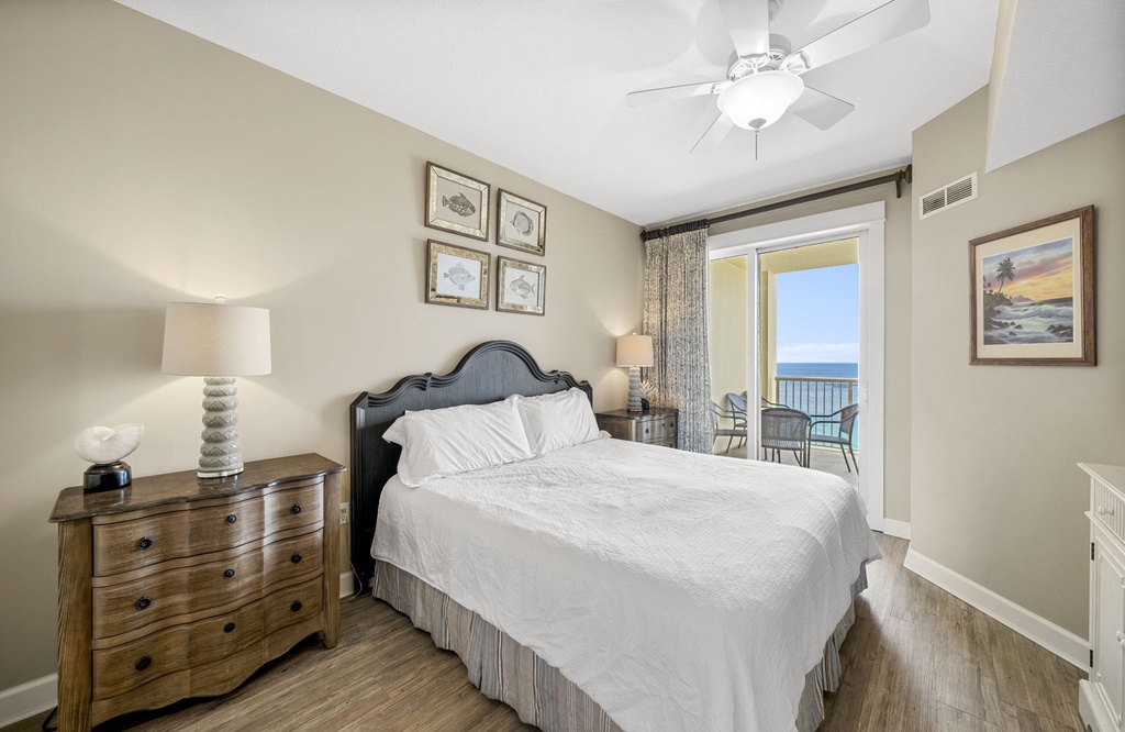 Relax in this coastal bedroom with balcony views of the ocean.