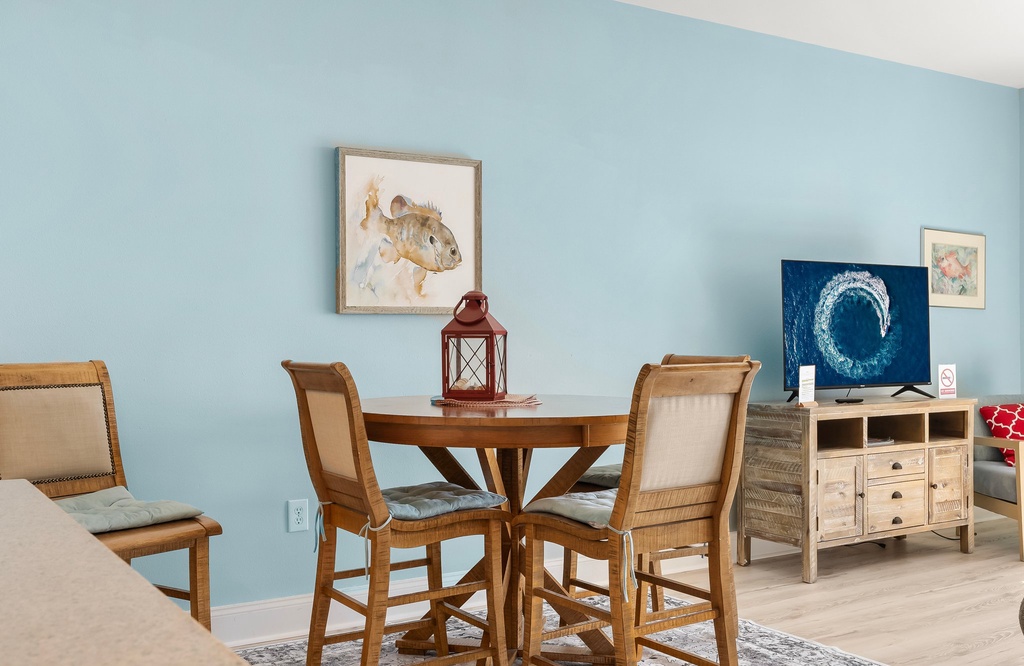 Cozy dining area with rustic wooden furniture and calming blue walls.