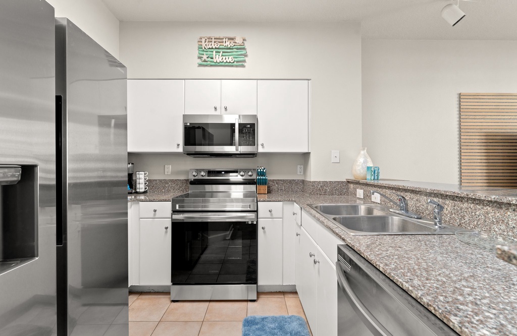 Modern kitchen with stainless steel appliances and granite countertops