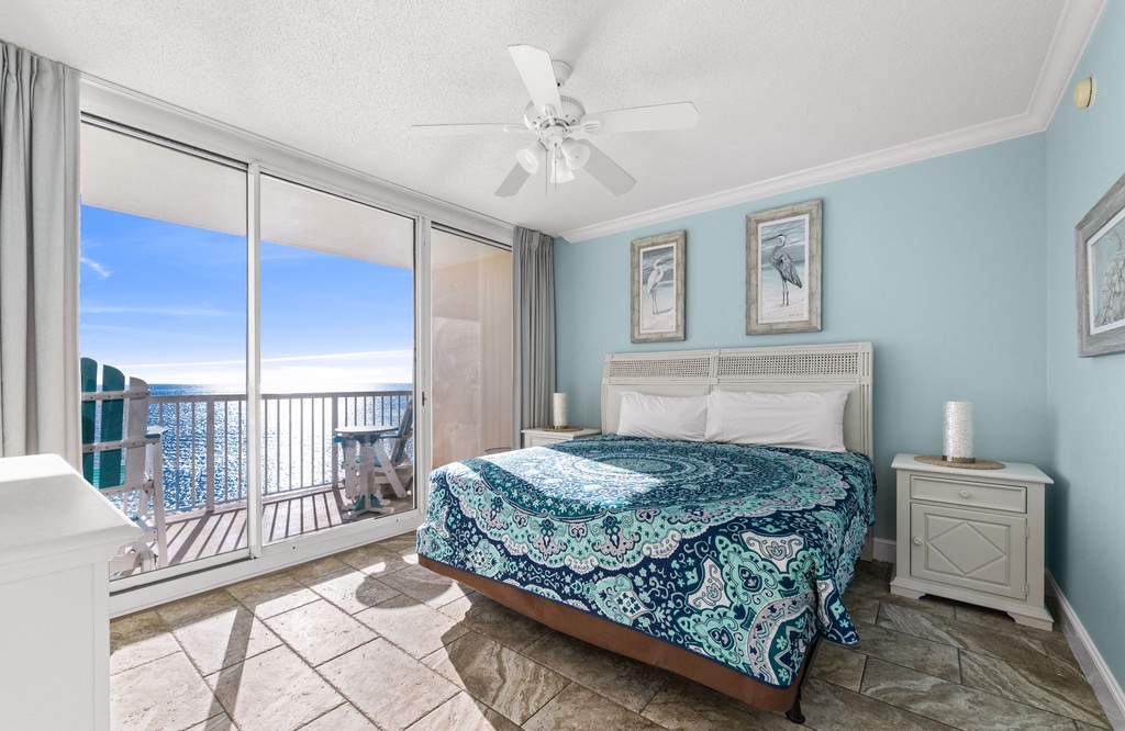Relax in this bright bedroom with ocean views and direct balcony access.