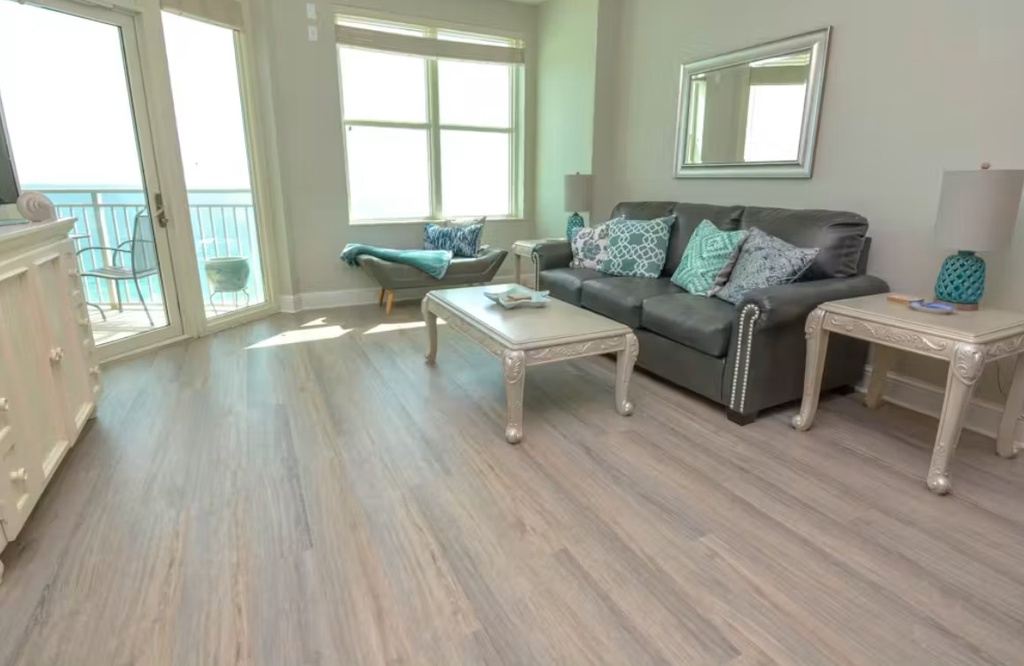 Sink into the plush sofa with turquoise accents and let the ocean breeze drift through your private balcony doors. The bright, open space feels like a breath of fresh air, where relaxation meets coastal elegance.