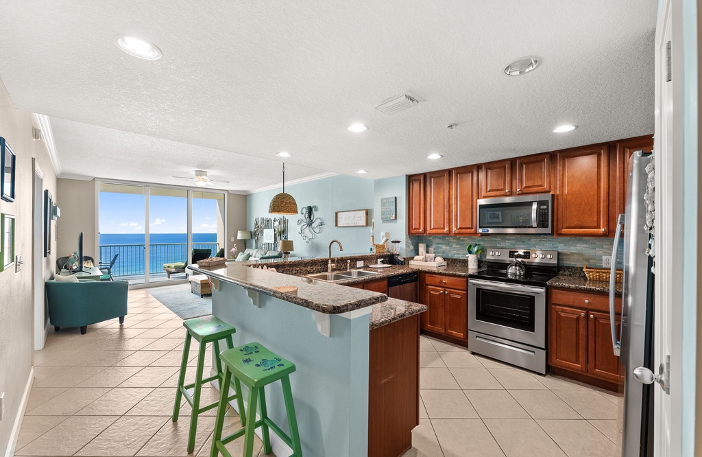 Your fully equipped kitchen flows seamlessly into the living area, where stunning ocean views greet you through expansive windows.