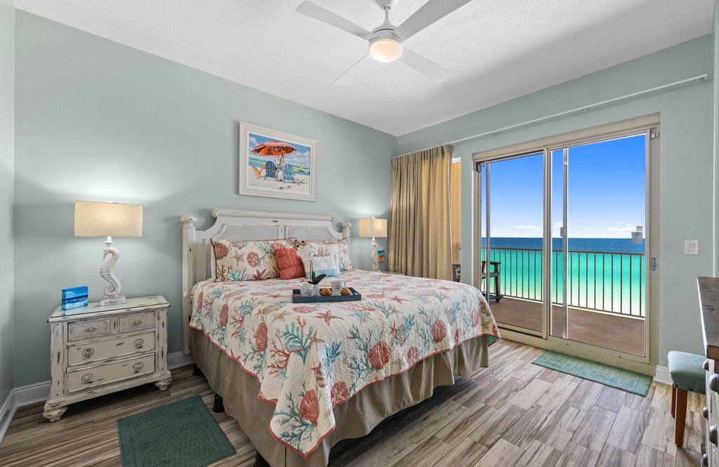 Relax in this coastal-themed bedroom with ocean views from the balcony.