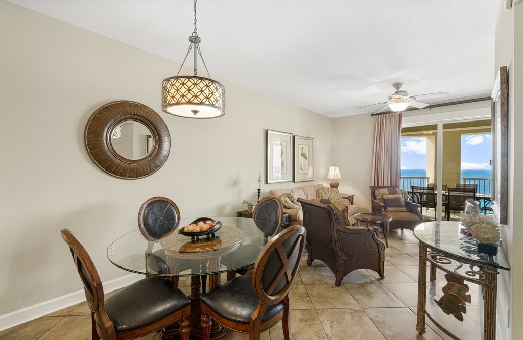 Relax in this coastal living room with ocean views and a glass dining table.