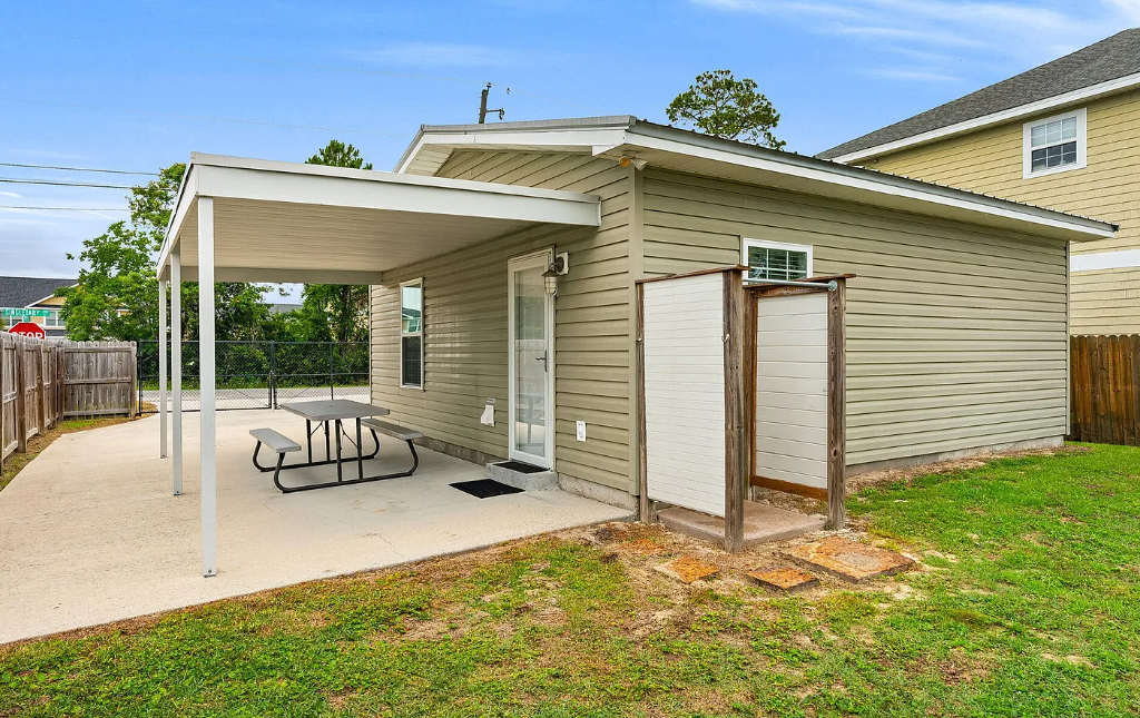 Outdoor space featuring covered parking and a private yard in a quiet residential area.