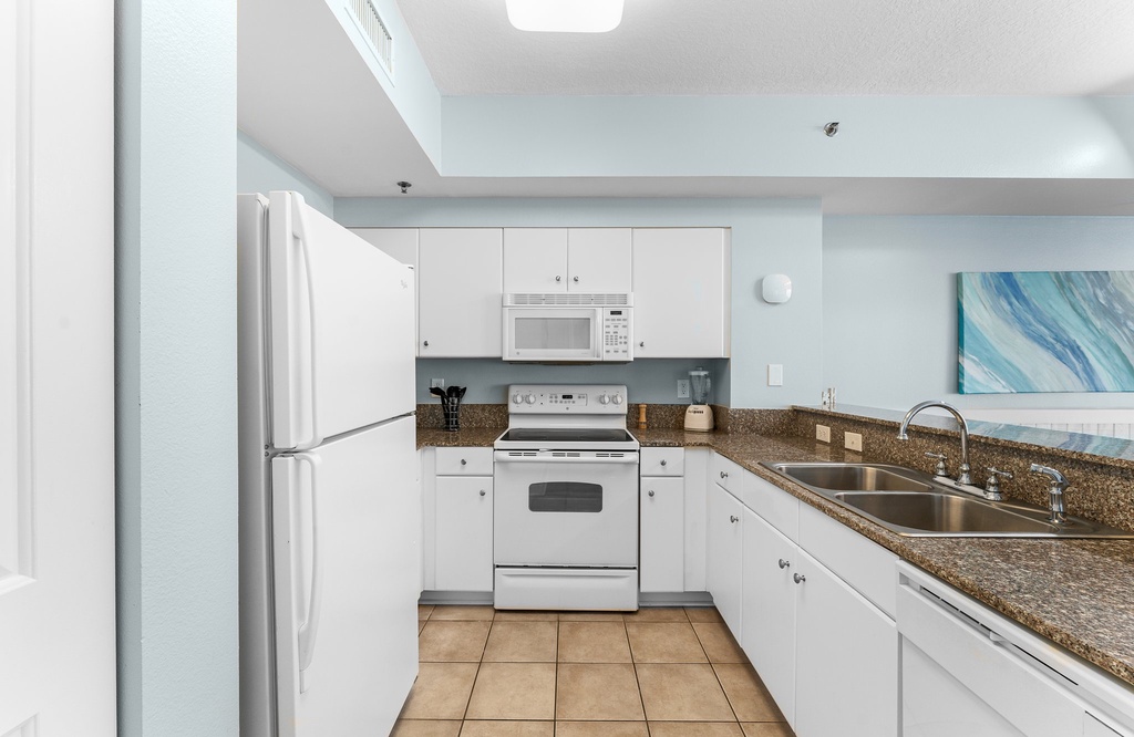 Modern kitchen with white appliances and granite countertops