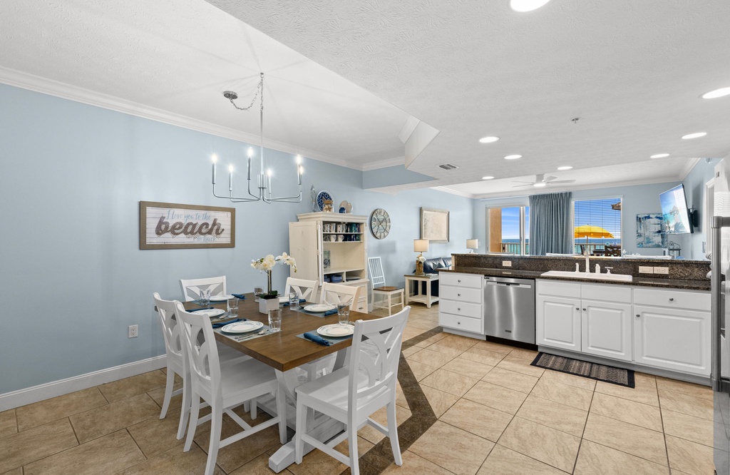 Open dining and kitchen area with coastal decor and ocean views.