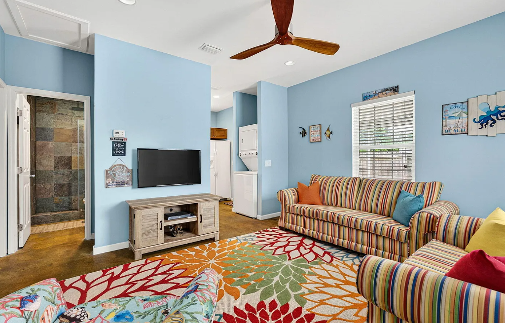 Kick back in this bright, cheerful living room with beachy vibes, colorful seating, and all the comforts you need to unwind together after sun-soaked adventures.