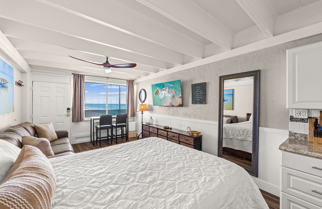 Your coastal bedroom retreat features exposed beam ceilings, charming décor, and a private dining nook. Step to the window and take in sweeping ocean views that stretch across the horizon.