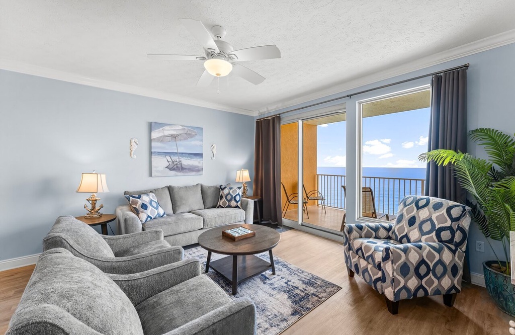 Unwind in your coastal-inspired living space with plush seating, coastal decor, and sweeping ocean views from your private balcony—your perfect retreat awaits.