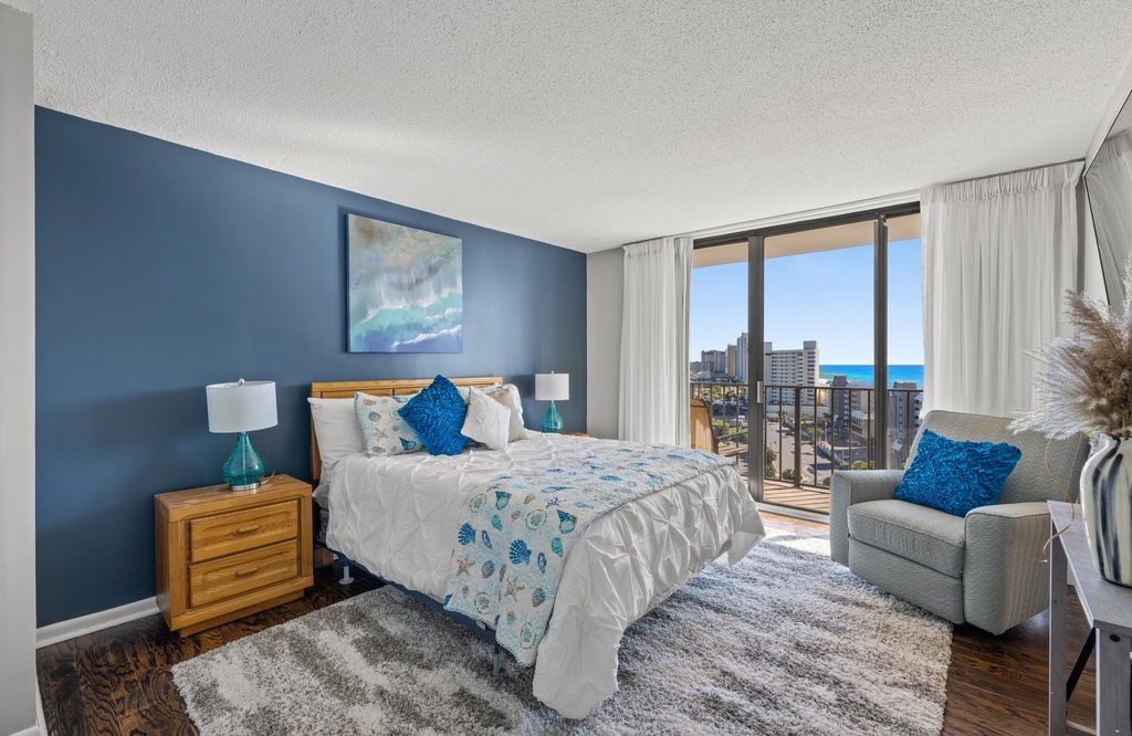 Relax in this modern bedroom with ocean views and natural light.