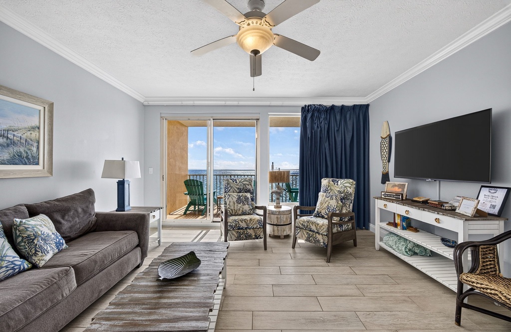 Settle into coastal comfort in your living room, where plush seating and soothing ocean breezes through the balcony doors create your perfect beach retreat.