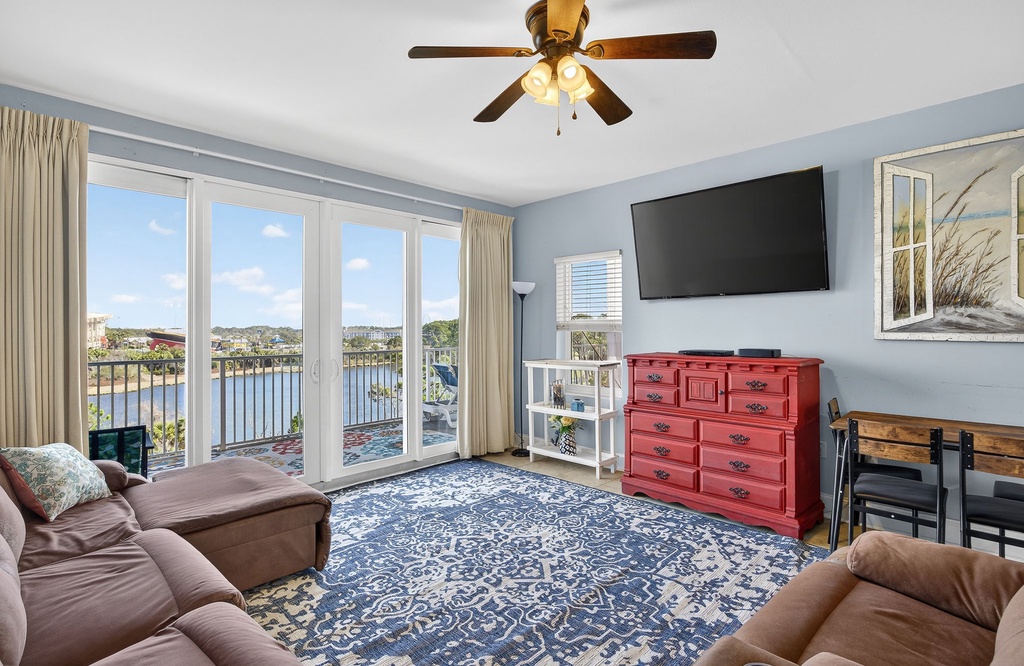 Relax in your spacious living room with stunning lake views through floor-to-ceiling windows, perfect for unwinding after a day of adventures.