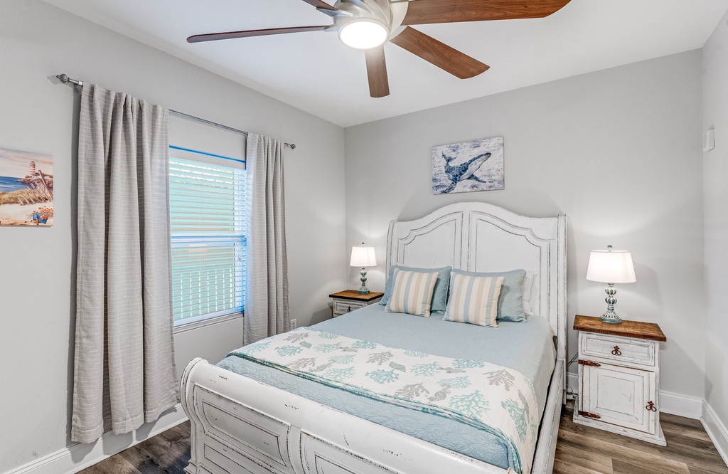 Cozy bedroom with a white wooden bed frame and soft natural lighting