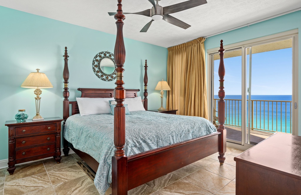 Relax in this ocean-view bedroom with classic wooden furnishings and natural light.