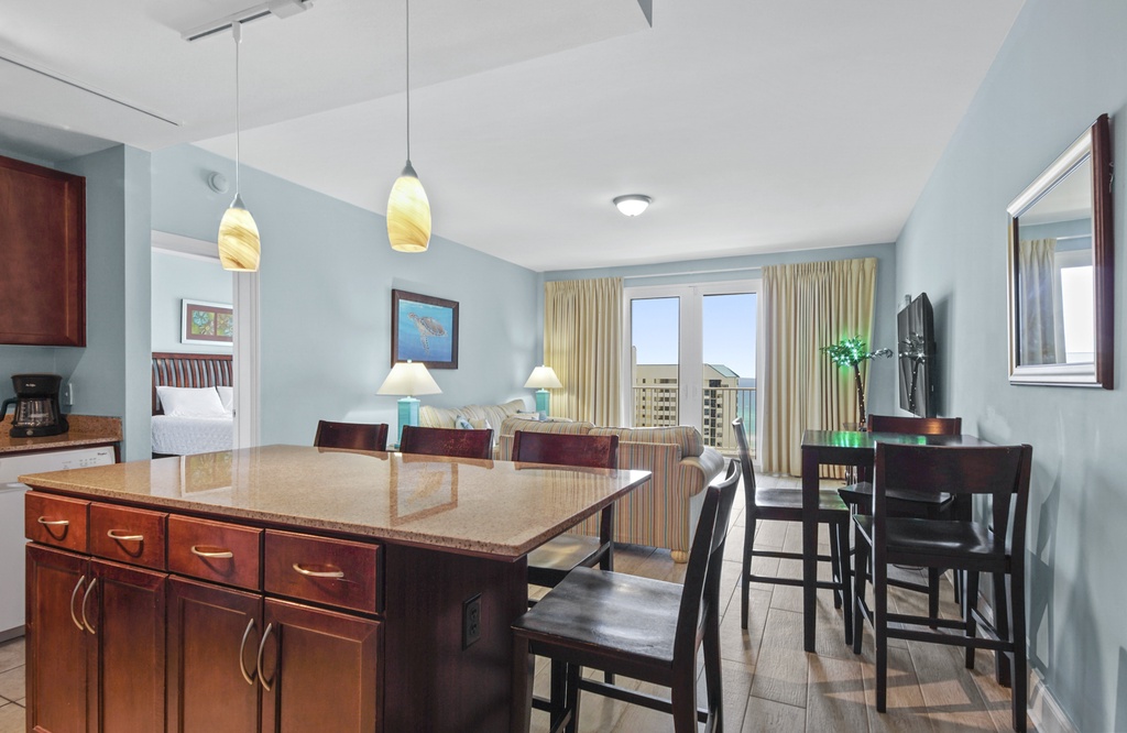 Open-concept living and dining area with city views and modern lighting.