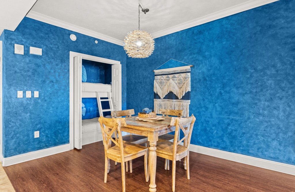 Gather around this charming rustic table where vibrant blue walls create a cozy atmosphere for your meals and conversations.