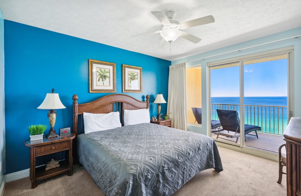 Relax in a cozy bedroom w/ balcony access, ocean views & a calm coastal feel