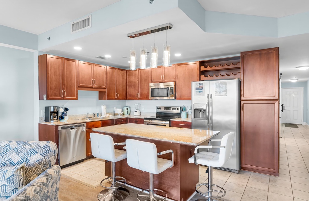 Modern kitchen with stainless steel appliances and a central island with seating.