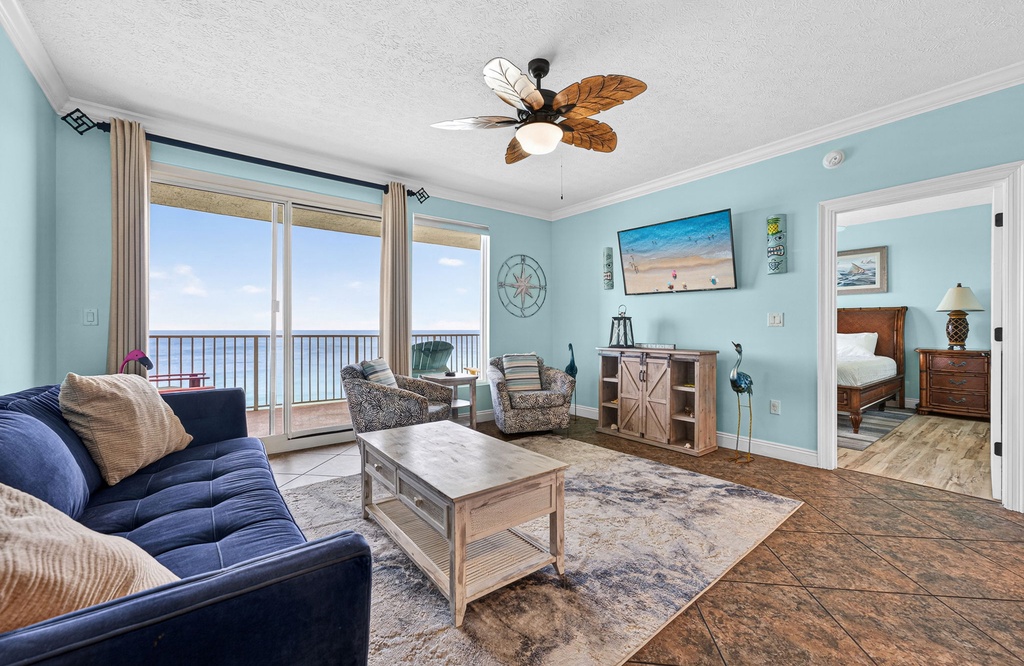 Relax in this coastal-style living room with ocean views and access to a balcony.