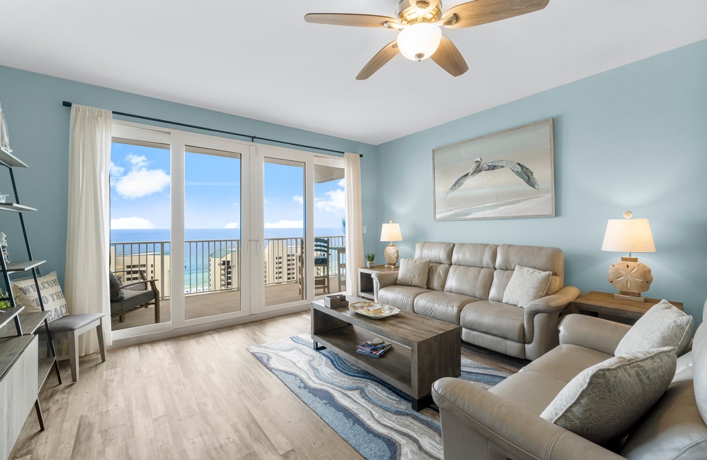 Relax in this coastal living room with ocean views through large glass doors.